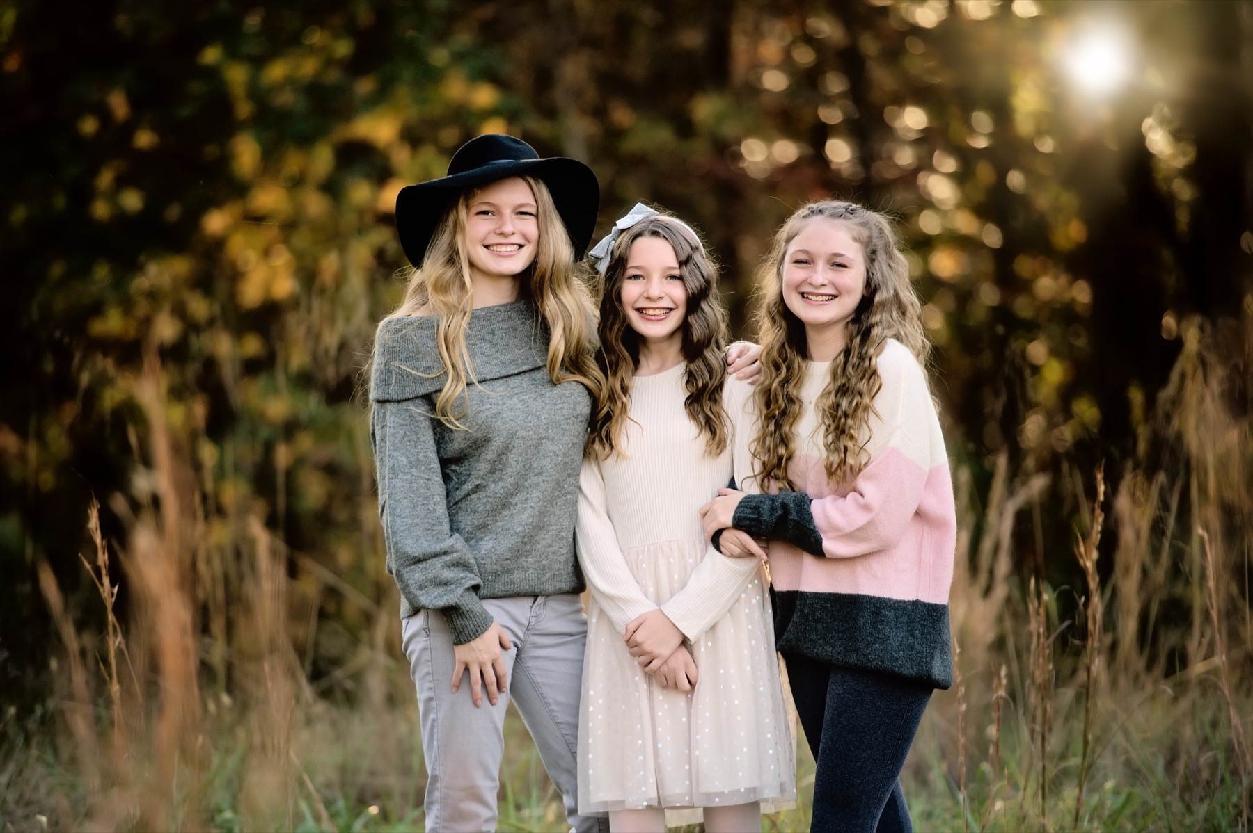 Three girls smiling during a portrait session