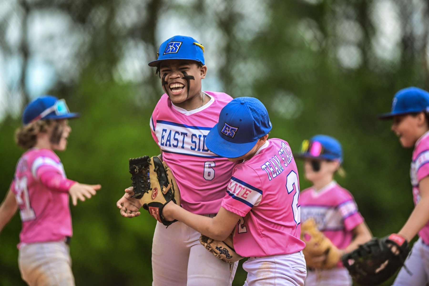 Youth baseball teammates celebrating together