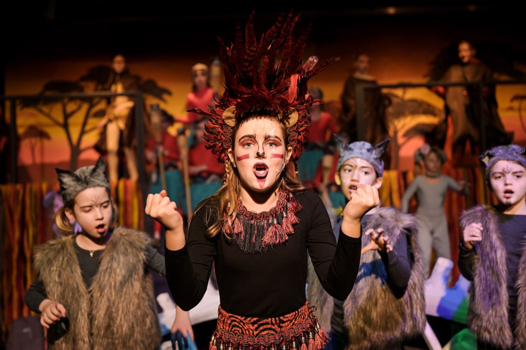 Young performer singing on stage in costume